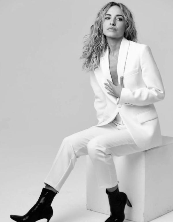 Meghan Carrasquillo in a Black-and-white photo wearing an all-white suit.