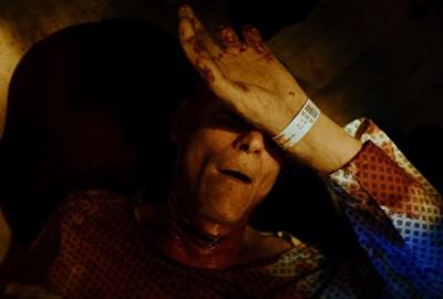 A hospital patient covers face with hand